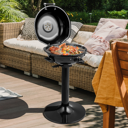 The outdoor grill with the lid open and food cooking on a patio with garden furniture