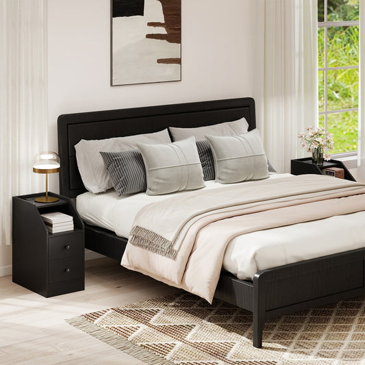 Two black bedside tables in a bedroom next to a bed