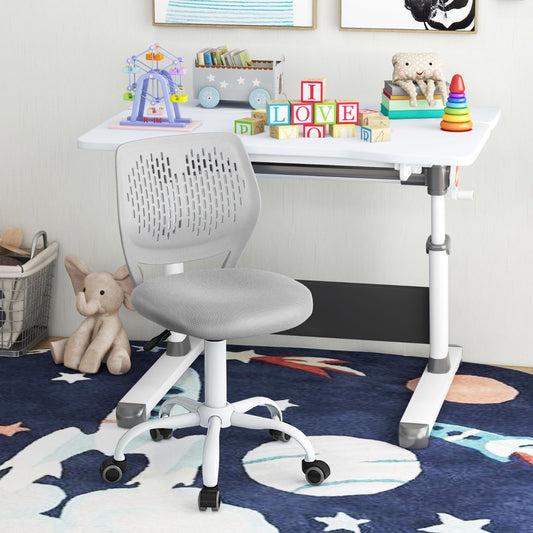 The kids chair positioned in front of a white desk in a child's bedroom with toys and a rug