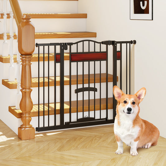 The extra wide pet gate installed at the bottom of a staircase with a corgi sitting in front