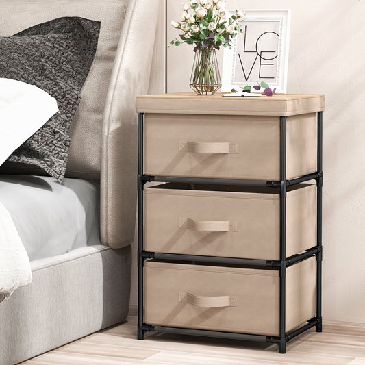 The fabric storage tower unit with removable lid next to a bed, showing its use as a bedside table
