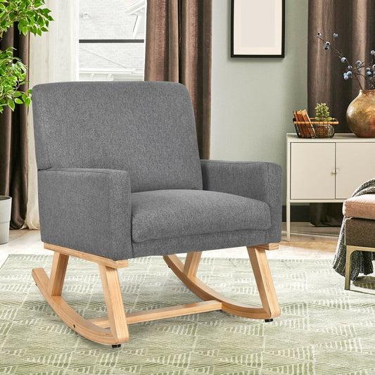Grey fabric rocking chair with wooden rockers in a living room setting
