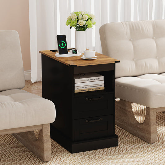 The nightstand placed between two beige armchairs in a bright living room