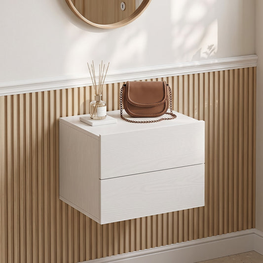 The wall mounted nightstand in white, fixed to a wall above a robot vacuum cleaner