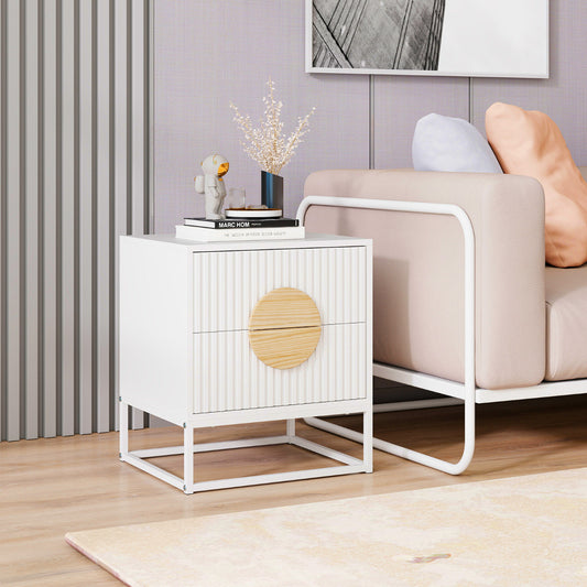 White fluted nightstand with wooden drawer fronts in a modern living room setting