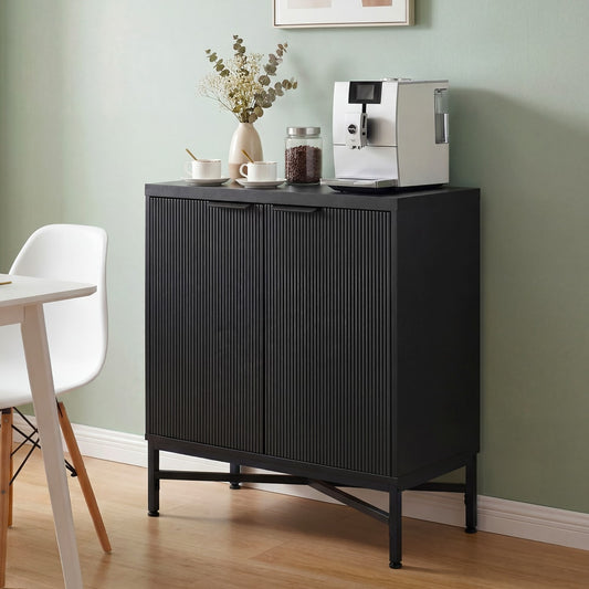 The black cabinet is shown in a dining room setting with a coffee machine on top