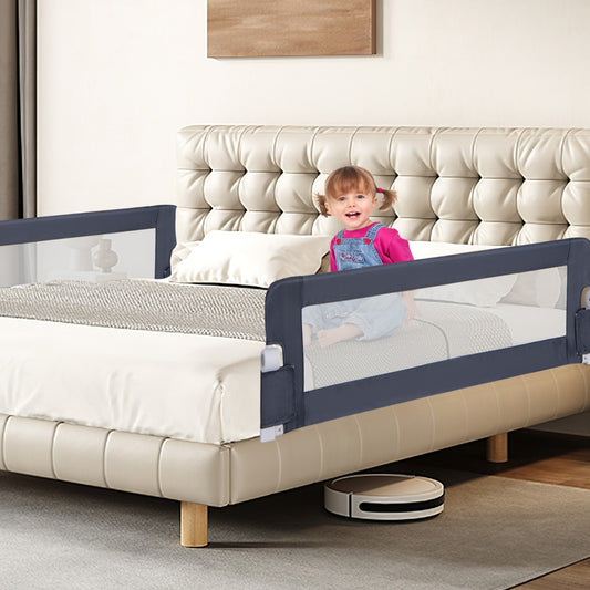 The grey bed rail installed on a double bed with a toddler sitting on it