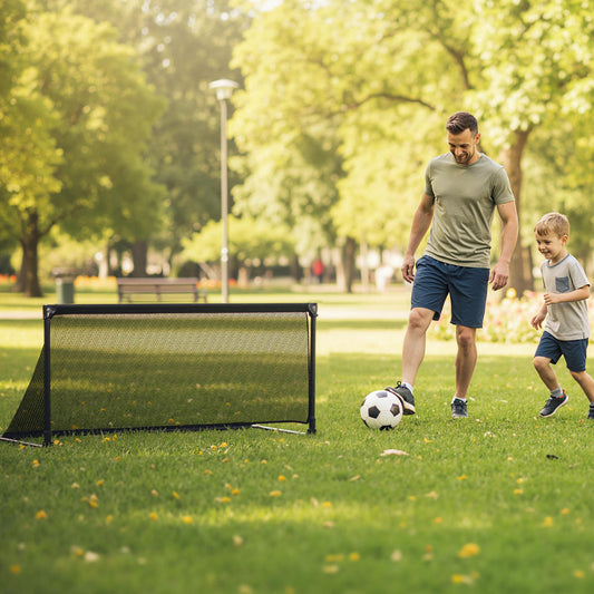 Father and son playing football with the pop-up soccer goal in a park
