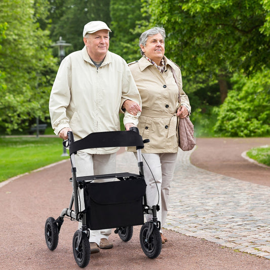 The rolling walker being used by an elderly man walking along a park path
