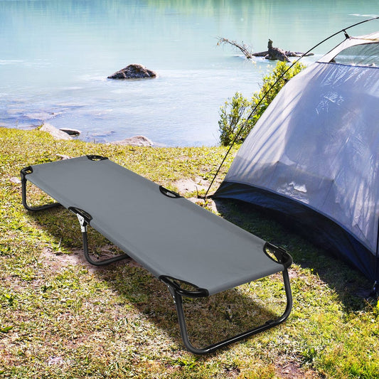 The camping furniture set up next to a tent by a lake