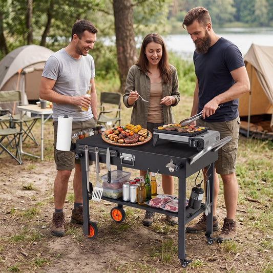 The outdoor grill cart being used by three friends at a campsite with food and drinks