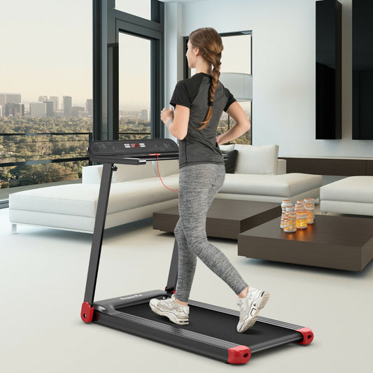 A woman running on the folding treadmill in a modern living room with city views