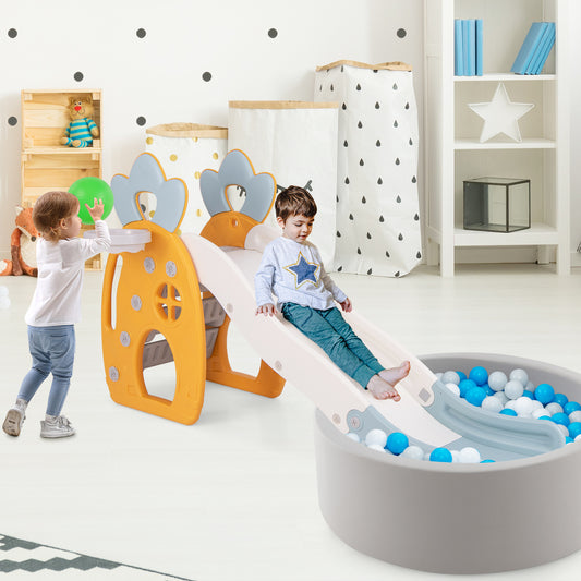 The kids slide positioned next to a grey ball pit in a child's bedroom