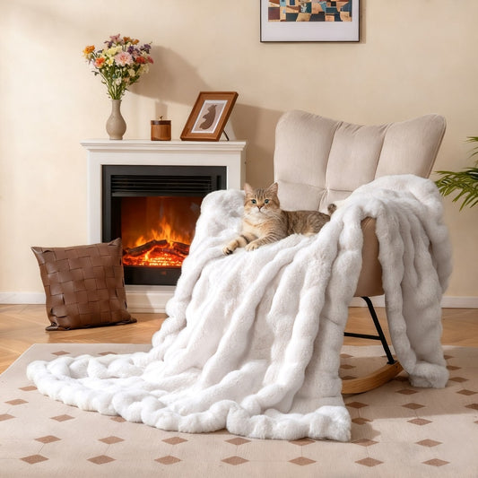 The plush rabbit fur bubble blanket draped over a rocking chair next to a fireplace with a cat resting on it