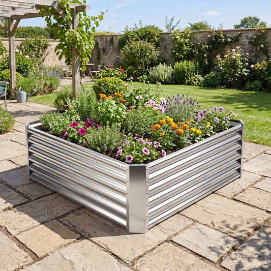 Galvanised raised garden bed filled with flowers and herbs in a garden setting