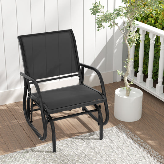 The patio rocking chair on a rug next to a potted plant on a balcony