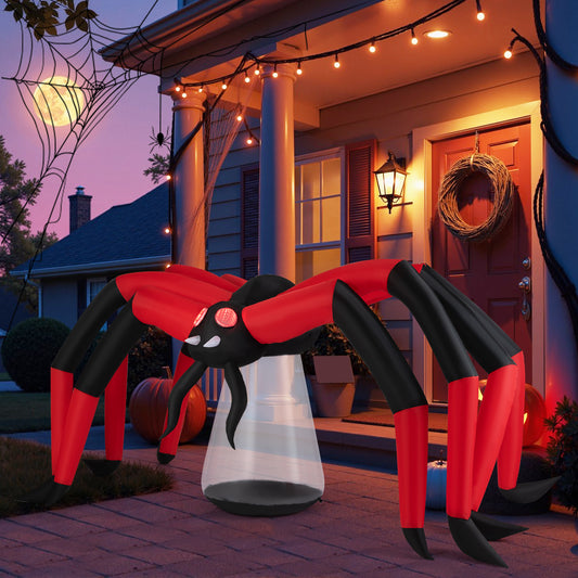 The inflatable spider in use on a patio at dusk, with a large moon and spooky decorations