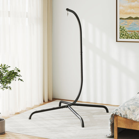 The metal hammock stand is shown in a bright room with a window and plants