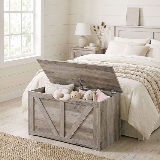 The grey wood-effect storage cabinet with its lid open, showing cushions and stuffed toys inside