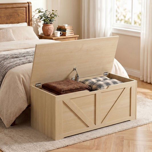 The storage box in a bedroom, used as a blanket chest at the foot of a bed
