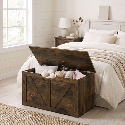The storage cabinet placed at the foot of a bed in a bedroom filled with soft toys and pillows