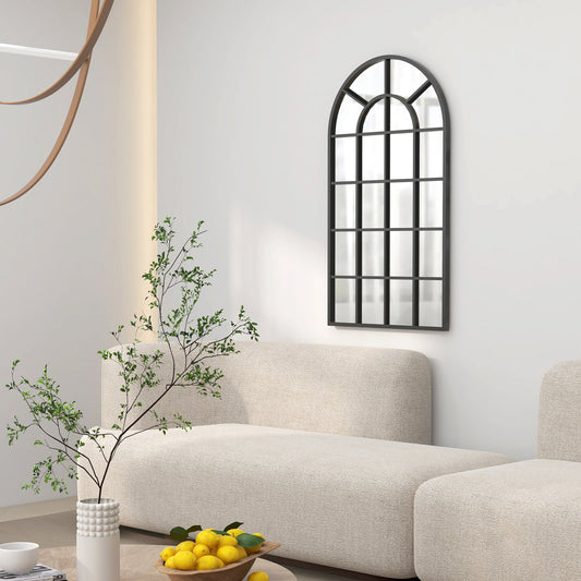 The wall mirror mounted on a white wall above a beige sofa in a bright living room setting