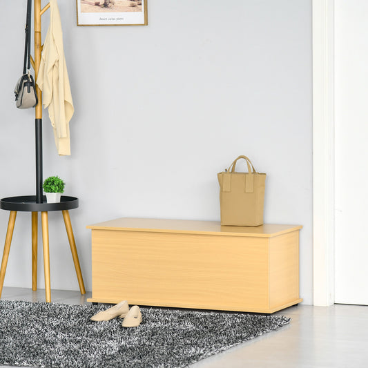 The storage trunk placed in a hallway with a bag on top and shoes on the rug