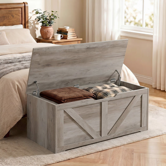 This storage cabinet is placed at the foot of a bed, holding blankets and pillows