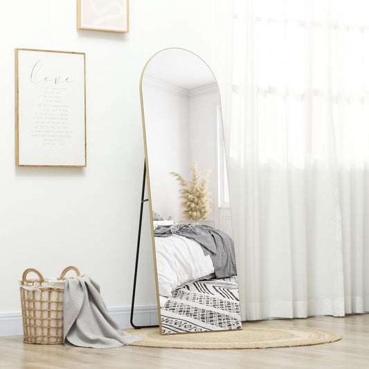 The arched full length mirror is shown in a bedroom setting on a rug