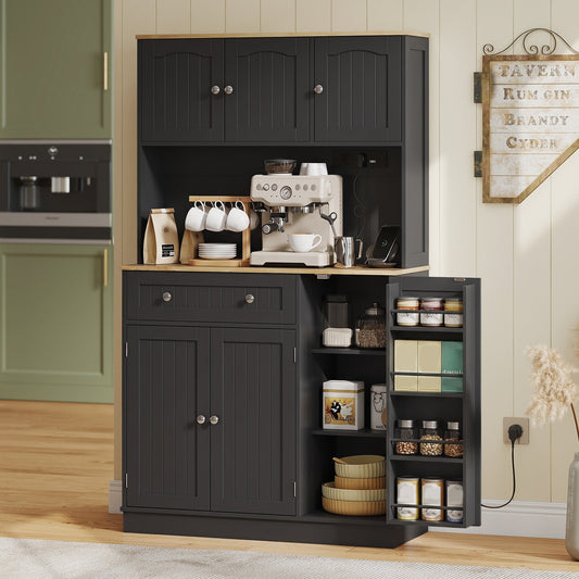The kitchen storage cabinet set up as a coffee station with a coffee machine and mugs on the counter