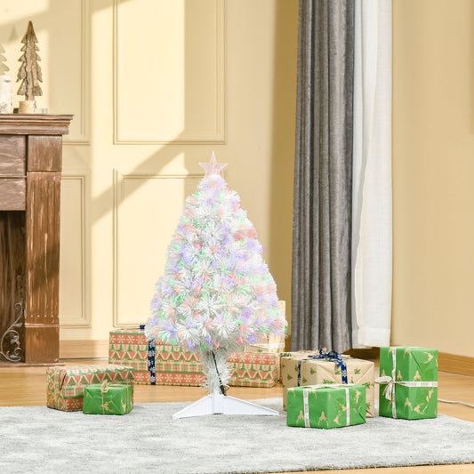 The white Christmas tree is set up in a room with presents around it