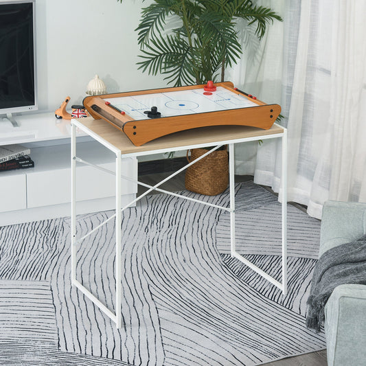 The game table placed on a white desk in a living room setting with a house plant nearby