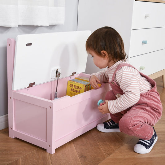 The kids storage bench with its lid open, showing a child placing a book inside