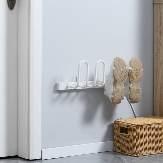 The electric shoe dryer mounted on a wall with a pair of trainers hanging on the drying arms