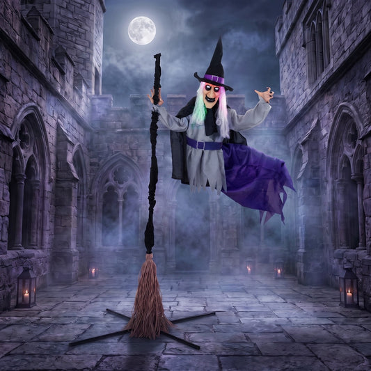 The animated flying witch decoration in a spooky castle setting at night