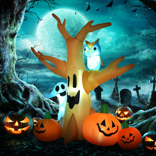 Halloween inflatable tree with ghost, pumpkins and owl in a spooky graveyard at night