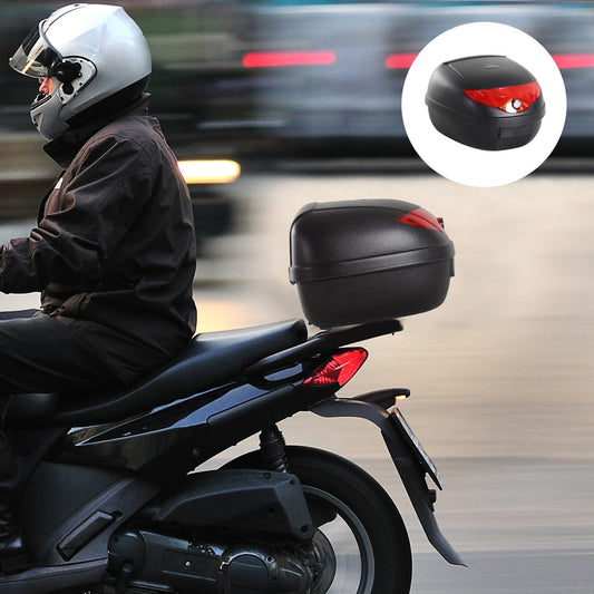 The motorcycle top box is mounted on the back of a scooter, showing its use while riding