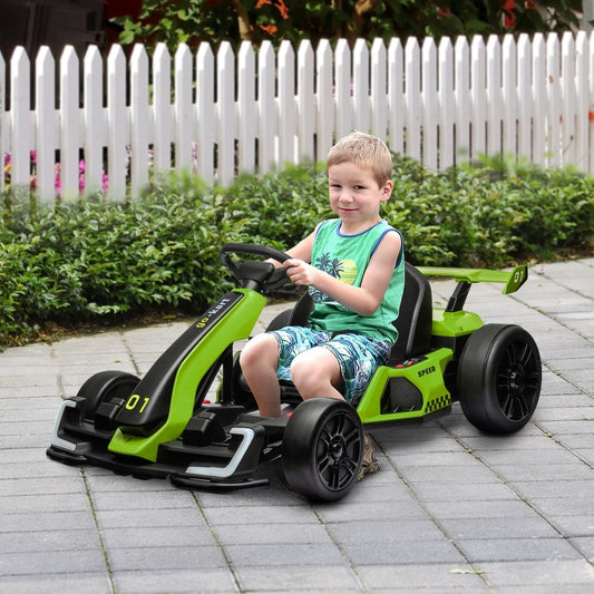 A young boy sits in the green electric go-kart, smiling and giving a thumbs up