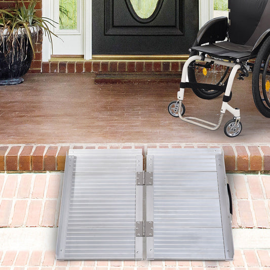 The folding wheelchair ramp is set up on a doorstep for a wheelchair to access