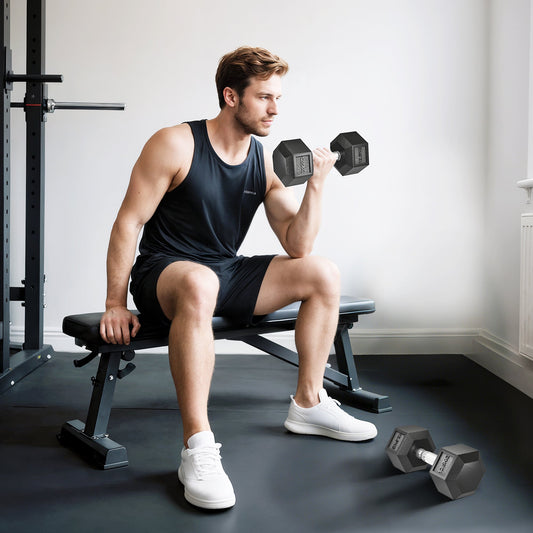 the dumbbells being used by a man sitting on a gym bench in a home workout space