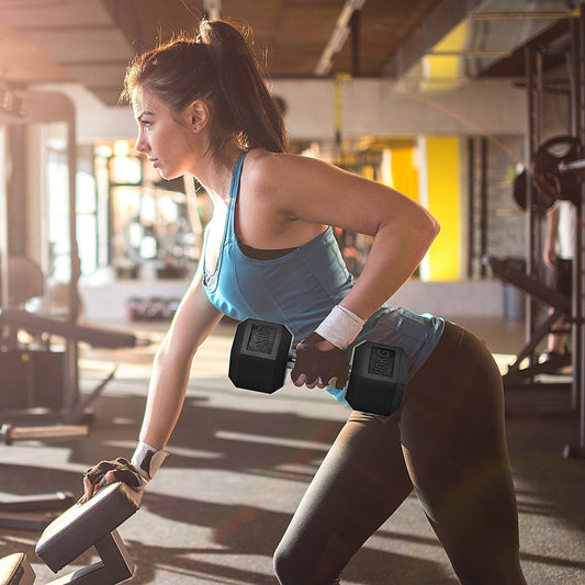 A woman performing a one arm dumbbell row exercise in a gym setting