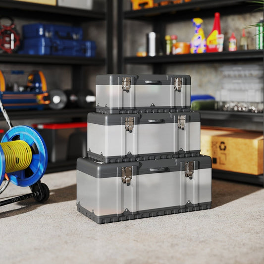 Three stainless steel tool boxes of varying sizes stacked together on a carpeted floor