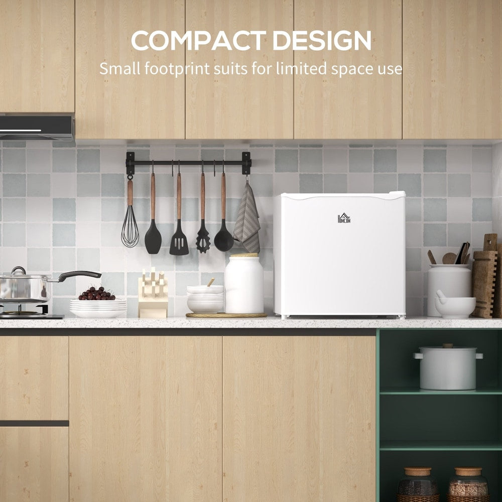 The compact white mini freezer is shown in a kitchen with cabinets and utensils