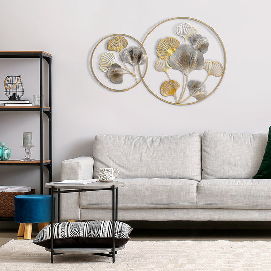 The modern ginkgo leaves wall sculpture in a living room above a sofa