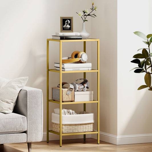 The gold tone four-tier shelving unit is shown in a living room with books and decorative items on its shelves