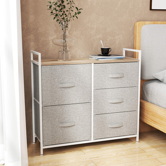The storage cabinet placed in a bedroom next to a bed with a vase and cup on top