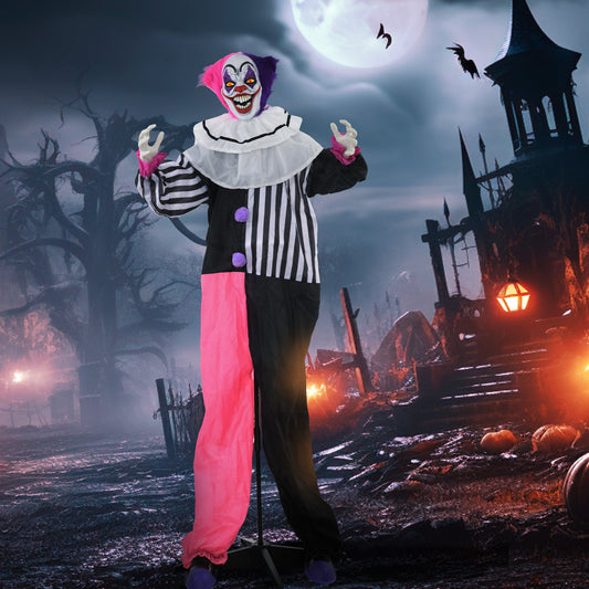 Scary laughing clown animatronic in a spooky outdoor setting at night