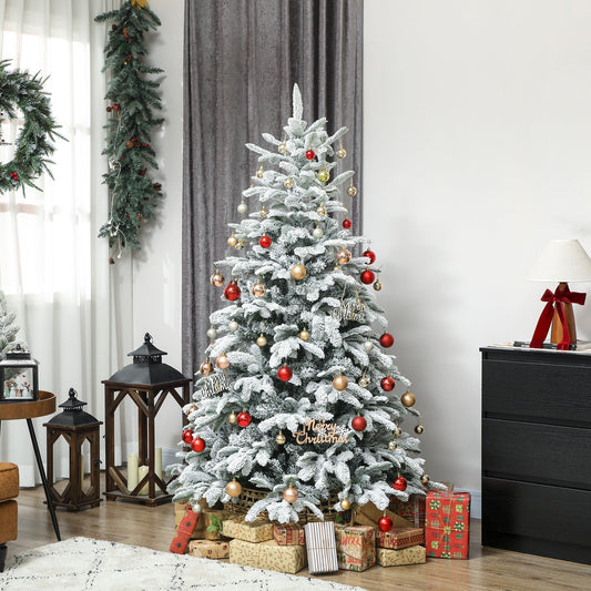The flocked Christmas tree is decorated with baubles and presents in a cosy room setting