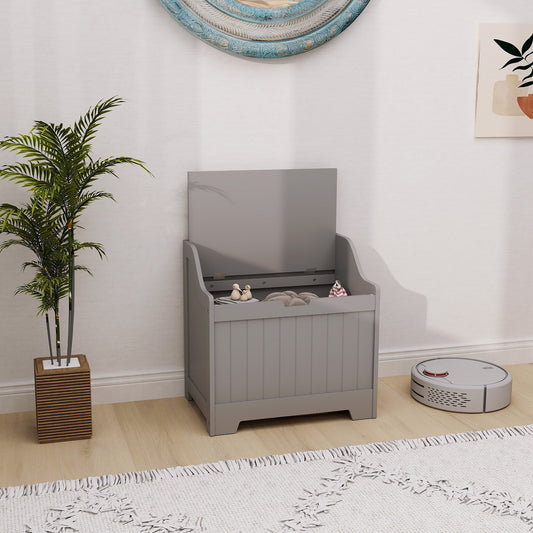 Grey storage cabinet with lid open, shown in a room with a plant and a robot vacuum cleaner