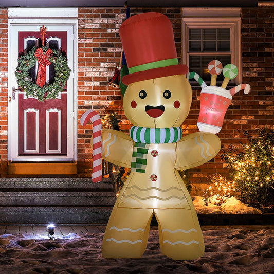 The inflatable gingerbread man display is set up on a lawn at night with festive lights